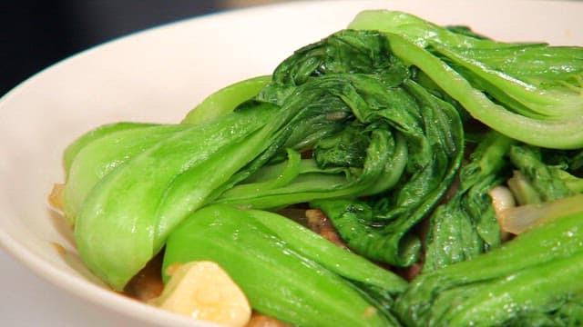 Stir-fried fresh bok choy in a white bowl