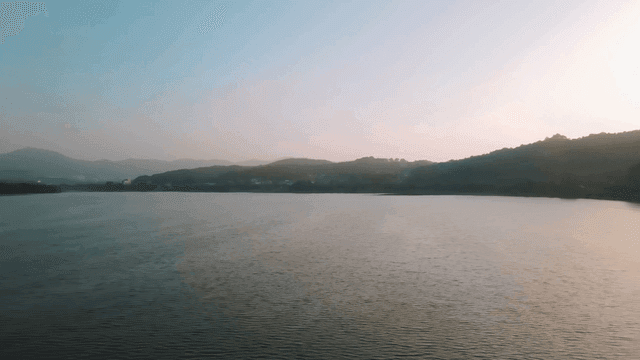 Tranquil lake with mountains visible in distance
