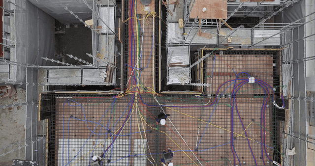 Construction site with scaffolding and cables