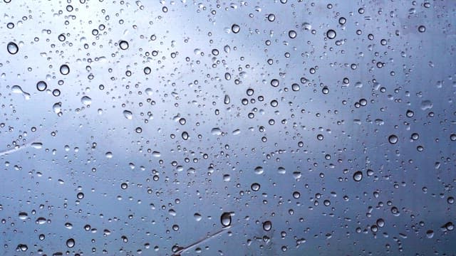 Raindrops on a window on a cloudy and rainy day