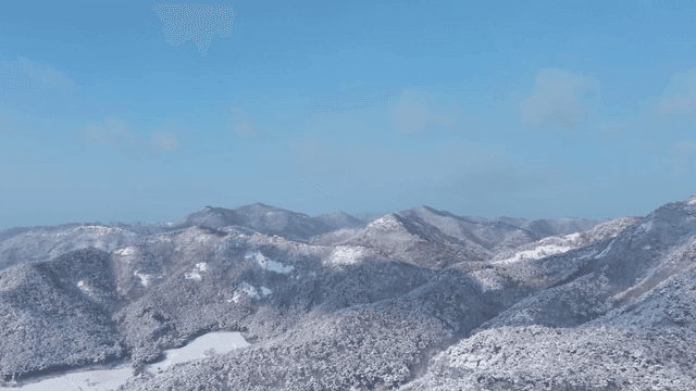 Snow-covered mountains under a clear sky