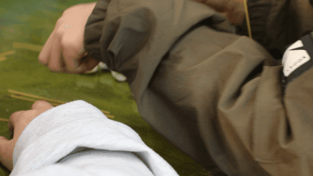 Elementary school students create structures with marshmallows and spaghetti noodles.