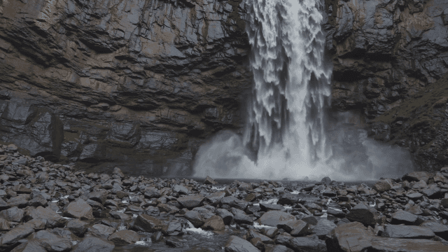 Majestic waterfall cascading down rocky cliff