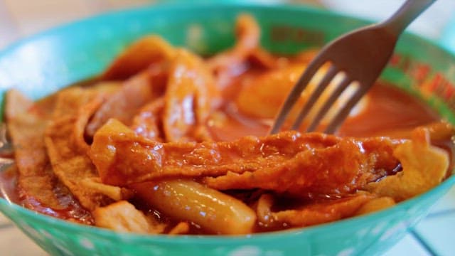 Picking up a Hot, Shiny Tteokbokki with a fork