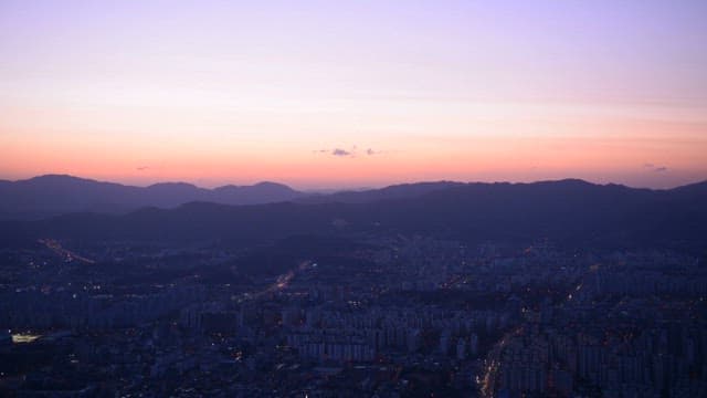 Twilight Cityscape with Mountains in the Background