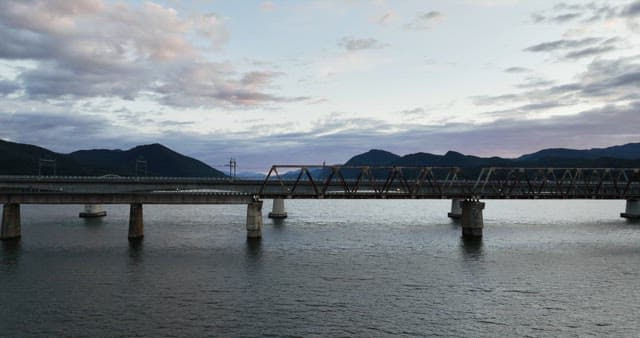 Bridge over a calm river at dusk