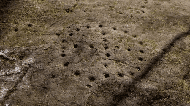 Rock surface with pattern of circular holes