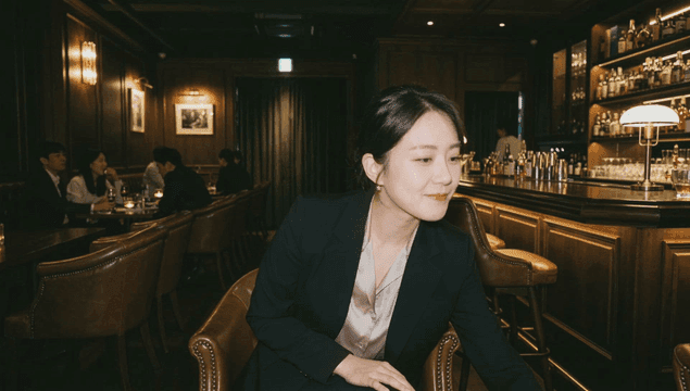 Woman drinking whiskey at bar