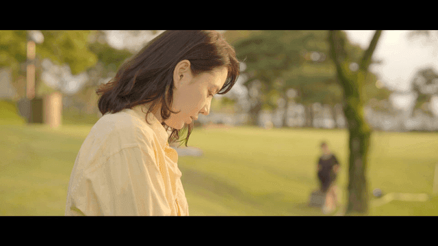 Profile of woman smiling peacefully in park