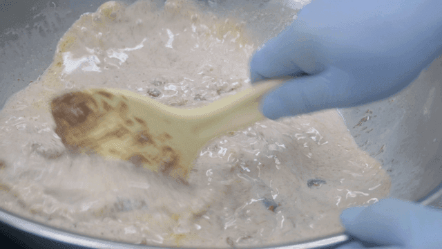 Mixing dough in a metal bowl