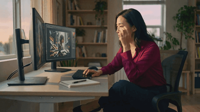 Woman doing graphics work on computer at home