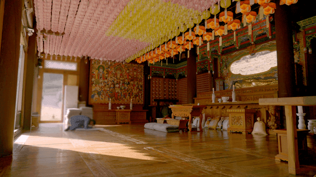 A person bowing in a decorated temple