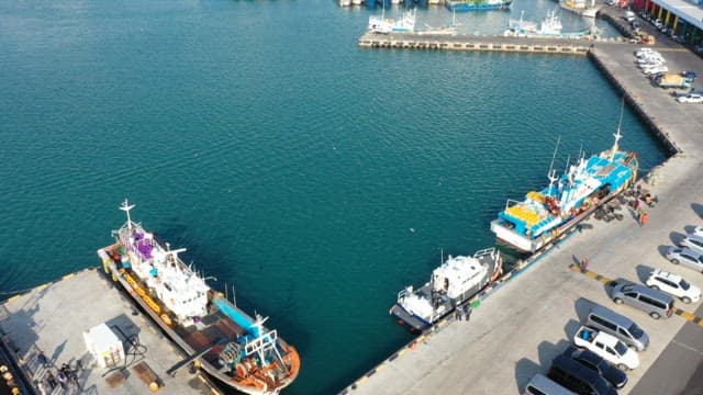 Peaceful coastal city port with anchored fishing boats