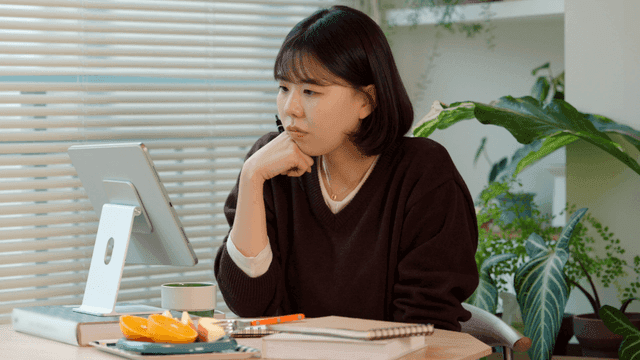 Young woman studying on tablet