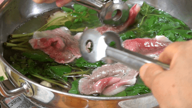 Cooking shabu-shabu with fresh greens