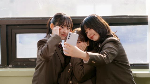 Students taking selfies and laughing