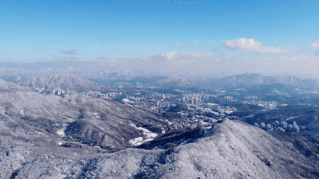 Snow-covered mountains and cityscape