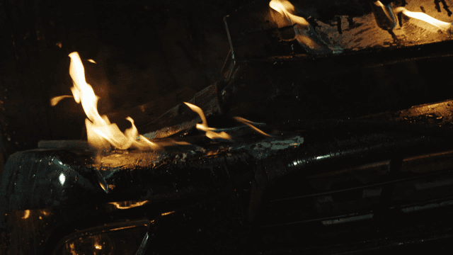 Car engulfed in flames at night