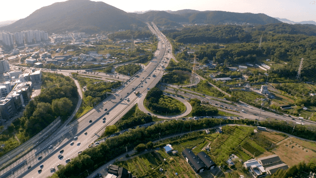 Busy highway interchange between mountains and rural area