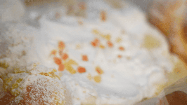A close-up of a creamy dessert with fruit