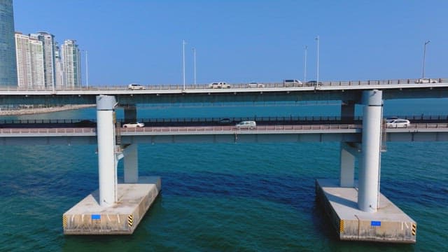 Gwangan Bridge scenery with many cars passing over the blue sea