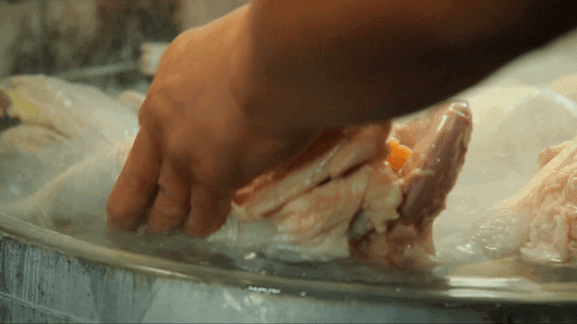 Chicken being boiled in a pot