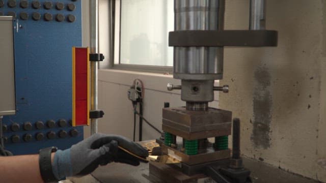 Machine pressing metal sheets in a factory