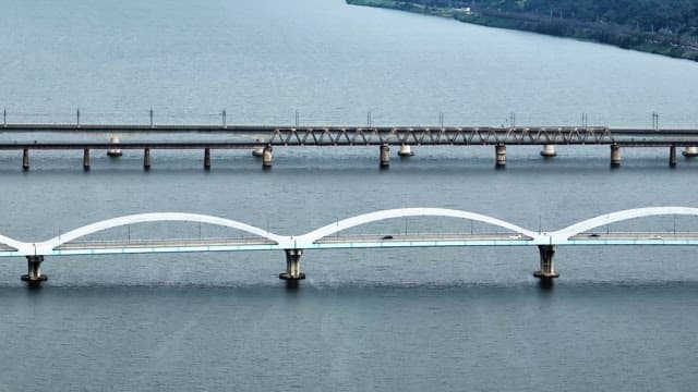 Bridges over rivers with cars passing by