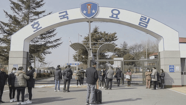 People gathered at entrance to army training camp