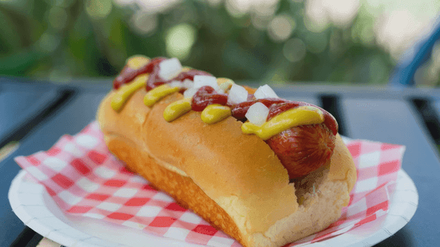 Hot dog topped with mustard and ketchup