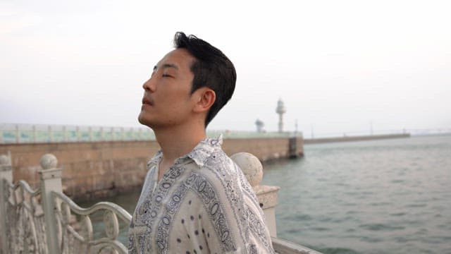 Man enjoying a peaceful moment by the sea