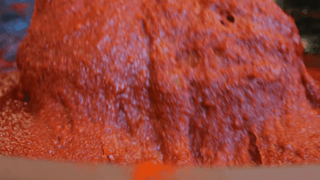 Spatula stirring red pepper paste in pot