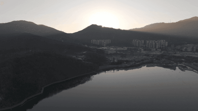 Sunrise over mountains and cityscape