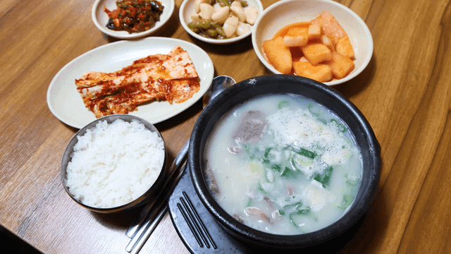 Korean beef soup with side dishes on a table