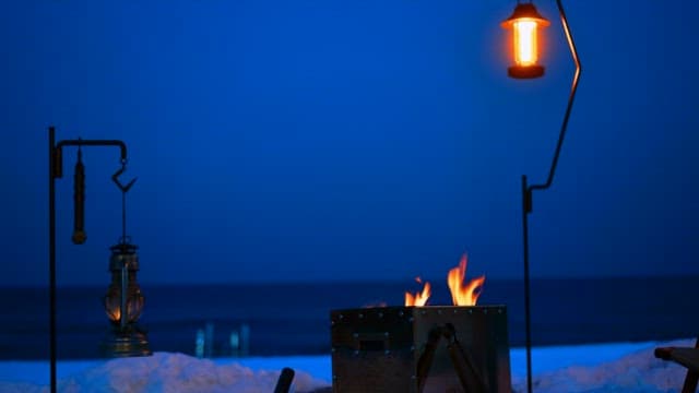 Cozy campfire at the beach on a snowy evening