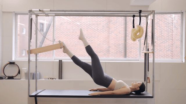 Woman exercising on a cadillac