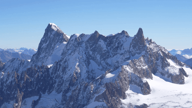 Snow-covered mountain peaks under clear sky