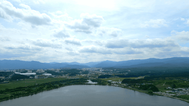 River scenery under cloudy sky with mountains in distance