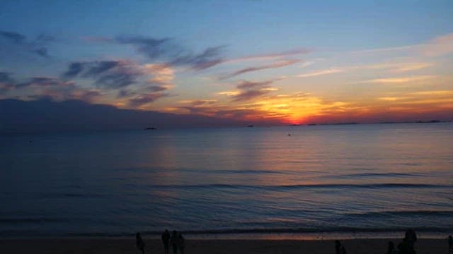 Sunset at the Beach with People Gathering