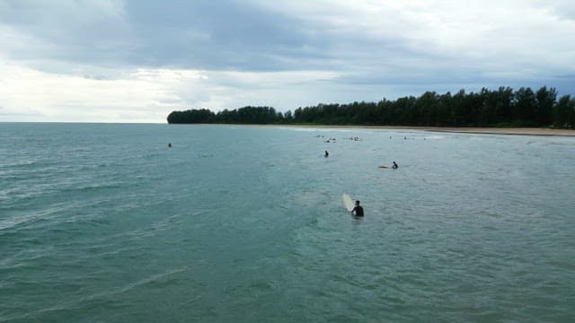 Surfers waiting for waves on a cloudy day