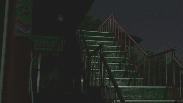 Rain falling on temple stairs at dark night