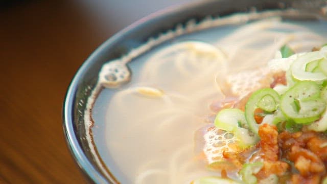 Fresh noodles with scallions and meat in soup served hot