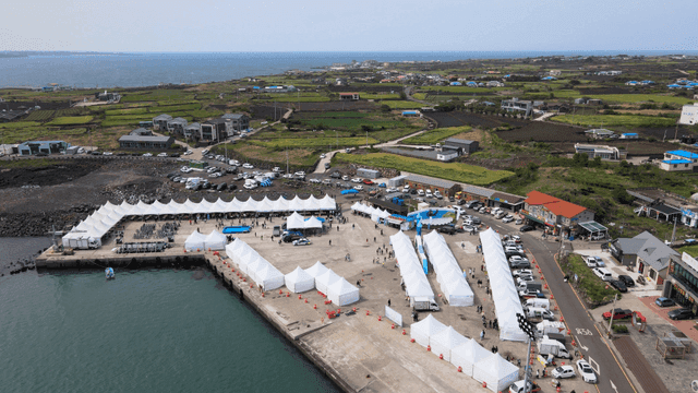 Coastal festival with tents and ocean view