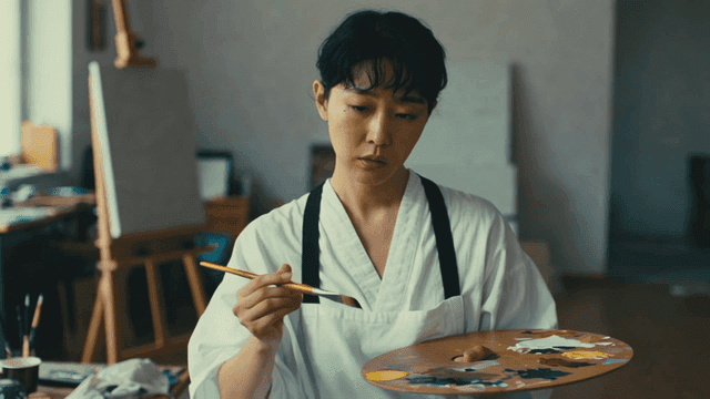 Artist painting in studio