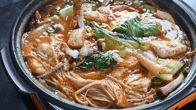 Seafood stew boiling in pot