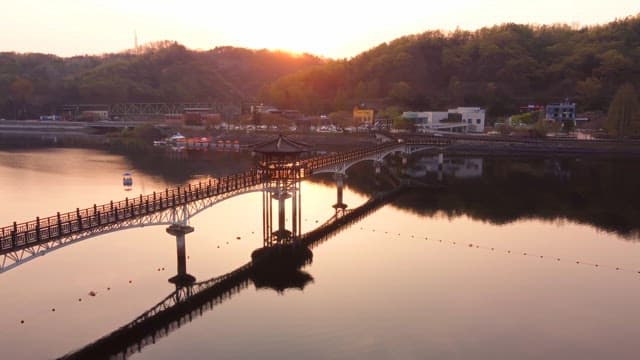 Scenic bridge over a calm river at sunset