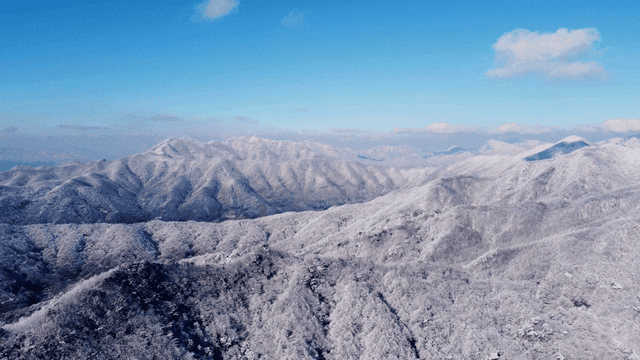 Snow-covered mountains under a clear blue sky