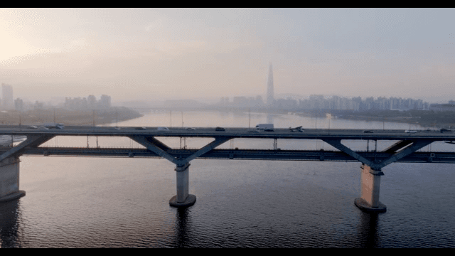 Bridge over a river with city skyline