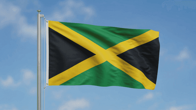 Jamaican flag waving against a clear sky