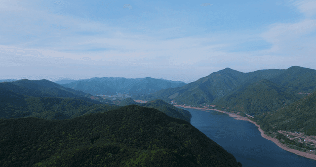 Vast landscape of green mountains and winding lakes